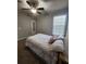 Bedroom has a window, ceiling fan, and neutral-colored carpet at 2571 Royston Dr, Duluth, GA 30097
