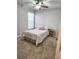 Cozy bedroom features a ceiling fan, window and neutral carpeting at 2571 Royston Dr, Duluth, GA 30097