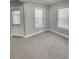 Cozy bedroom featuring neutral walls, plush carpet, and bright windows at 2571 Royston Dr, Duluth, GA 30097