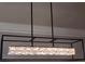 Close-up of a modern, boxy chandelier with crystal accents, adding a touch of contemporary elegance at 2571 Royston Dr, Duluth, GA 30097