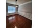 Formal dining room featuring hardwood floors, wainscoting, a modern chandelier, and ample natural light at 2571 Royston Dr, Duluth, GA 30097
