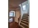 Foyer featuring stairs, hardwood floors, and views into the dining room, seamlessly connecting spaces at 2571 Royston Dr, Duluth, GA 30097