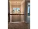 Hallway with a decorative chandelier, window, and decorative railing at 2571 Royston Dr, Duluth, GA 30097