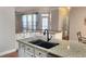 Bright kitchen features granite counters, stainless steel appliances, and a modern dark faucet fixture at 2571 Royston Dr, Duluth, GA 30097