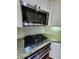 Close up of the kitchen featuring stainless steel appliances, granite countertops, and white cabinets at 2571 Royston Dr, Duluth, GA 30097