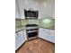 Modern kitchen boasts stainless steel appliances and white cabinets with dark hardware at 2571 Royston Dr, Duluth, GA 30097