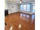 Sunlit living room featuring hardwood floors, fireplace, and large windows, a comfortable gathering space at 2571 Royston Dr, Duluth, GA 30097