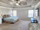 Spacious primary bedroom featuring large windows and a ceiling fan at 2571 Royston Dr, Duluth, GA 30097