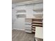 Spacious walk-in closet featuring built-in shelves and pull-out storage drawers at 2571 Royston Dr, Duluth, GA 30097