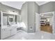 Modern bathroom featuring a double vanity, white cabinetry, a large mirror and opens to the main bedroom at 1117 Bridgemill Ave, Canton, GA 30114