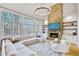 Living room featuring a stone fireplace, a cathedral ceiling, and large windows at 1117 Bridgemill Ave, Canton, GA 30114