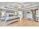 Nicely staged main bedroom with decorative ceilings, neutral paint, hardwood floors, and ensuite bath at 1117 Bridgemill Ave, Canton, GA 30114