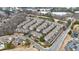 Aerial view of a dense townhome community, a lake, and businesses at 2368 Saint Davids Nw Sq # 4, Kennesaw, GA 30152
