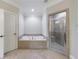Bright bathroom featuring soaking tub, step-in shower with white cabinets at 2368 Saint Davids Nw Sq # 4, Kennesaw, GA 30152