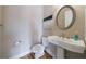 Stylish bathroom with a round mirror, vanity with a white basin, toilet, and neutral wall color at 2368 Saint Davids Nw Sq # 4, Kennesaw, GA 30152
