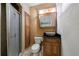 Unique bathroom featuring a vessel sink, wood cabinets, and stone tiled floors at 2368 Saint Davids Nw Sq # 4, Kennesaw, GA 30152