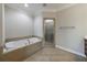 Luxurious bathroom featuring a tiled soaking tub and a separate shower at 2368 Saint Davids Nw Sq # 4, Kennesaw, GA 30152