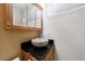 Charming bathroom with a stone vessel sink, dark countertop, and wood vanity at 2368 Saint Davids Nw Sq # 4, Kennesaw, GA 30152