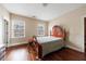 Bedroom featuring hardwood floors and two windows, providing natural light at 2368 Saint Davids Nw Sq # 4, Kennesaw, GA 30152