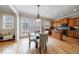 Well-lit kitchen and dining area, with wood cabinets, natural light, and views to outdoors at 2368 Saint Davids Nw Sq # 4, Kennesaw, GA 30152
