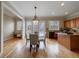 Open-concept dining area with hardwood floors connecting kitchen and seating nook at 2368 Saint Davids Nw Sq # 4, Kennesaw, GA 30152