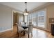 Bright dining area with hardwood floors, chandelier, and large windows at 2368 Saint Davids Nw Sq # 4, Kennesaw, GA 30152