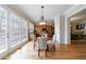 Dining area and kitchen view with wood floors, lighting, and outdoor view at 2368 Saint Davids Nw Sq # 4, Kennesaw, GA 30152