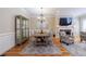 Cozy dining area featuring wood table, modern chandelier, and hardwood floors at 2368 Saint Davids Nw Sq # 4, Kennesaw, GA 30152