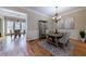 Bright dining room with chandelier lighting, seating for six, and access to a patio at 2368 Saint Davids Nw Sq # 4, Kennesaw, GA 30152