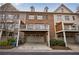 Rear exterior view of brick townhomes with garages and decks at 2368 Saint Davids Nw Sq # 4, Kennesaw, GA 30152