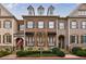 Charming brick townhome with black awnings, dormer windows, and manicured landscaping at 2368 Saint Davids Nw Sq # 4, Kennesaw, GA 30152