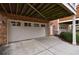 A two car garage with a wide concrete driveway and brick facade at 2368 Saint Davids Nw Sq # 4, Kennesaw, GA 30152