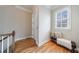 Hallway with hardwood floors and a bench beneath a window for comfortable seating and natural light at 2368 Saint Davids Nw Sq # 4, Kennesaw, GA 30152