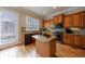 Charming kitchen with wooden cabinetry, granite countertops and an island at 2368 Saint Davids Nw Sq # 4, Kennesaw, GA 30152