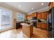 Charming kitchen with wooden cabinetry, granite countertops and an island at 2368 Saint Davids Nw Sq # 4, Kennesaw, GA 30152