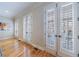 Living Room featuring hardwood floors and several windows and doors with white shutters at 2368 Saint Davids Nw Sq # 4, Kennesaw, GA 30152