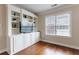 Comfortable Living Room featuring hardwood floors, built-in shelving, and natural light from a window at 2368 Saint Davids Nw Sq # 4, Kennesaw, GA 30152