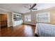 Bright main bedroom featuring hardwood floors, a ceiling fan, and built-in shelving at 2368 Saint Davids Nw Sq # 4, Kennesaw, GA 30152
