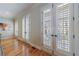 Hallway with 3 french door access points to outdoor patio, wood floors, and shuttered glass at 2368 Saint Davids Nw Sq # 4, Kennesaw, GA 30152