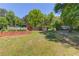 Large grassy backyard area with mature landscaping and a wooded perimeter at 3625 Knoll Crest Trl, Buford, GA 30519