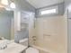 Cozy bathroom with tub/shower combination, cabinet, and a bright window for natural light at 3625 Knoll Crest Trl, Buford, GA 30519