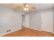 Bedroom with hardwood floors, ceiling fan, and closet, creating a comfortable space at 3625 Knoll Crest Trl, Buford, GA 30519