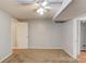 Carpeted bedroom with light gray walls and a ceiling fan, offering a serene and comfortable living space at 3625 Knoll Crest Trl, Buford, GA 30519