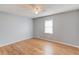 Bedroom featuring hardwood floors, a bright window and neutral paint providing a tranquil space at 3625 Knoll Crest Trl, Buford, GA 30519