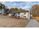 The exterior of the house with a long driveway and landscaping in neutral tones at 3625 Knoll Crest Trl, Buford, GA 30519