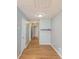 Inviting hallway with hardwood floors and neutral paint, illuminated by a recessed ceiling light at 3625 Knoll Crest Trl, Buford, GA 30519