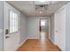 Hallway with light blue walls, wooden floors, and white doors to other rooms at 3625 Knoll Crest Trl, Buford, GA 30519
