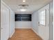Hallway with light blue walls, wooden floors, white doors, and a built-in dark shelf at 3625 Knoll Crest Trl, Buford, GA 30519