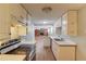 Clean kitchen featuring white cabinets, countertops, and modern appliances; looking towards living area at 3625 Knoll Crest Trl, Buford, GA 30519
