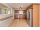 Open kitchen features stainless steel appliances, tile floors, and wood cabinets at 3625 Knoll Crest Trl, Buford, GA 30519